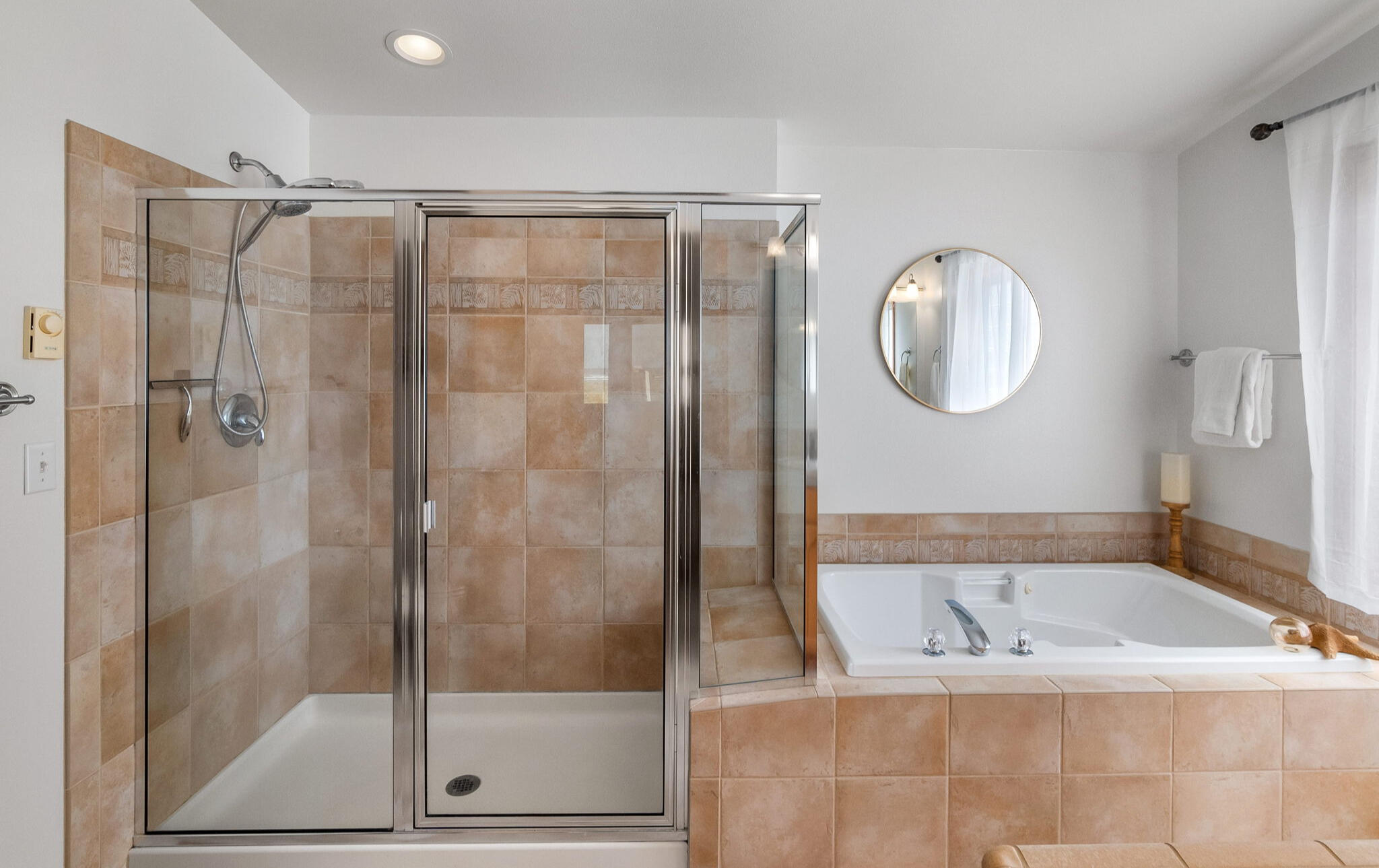 Spa-style primary bath with soaking tub and walk-in shower